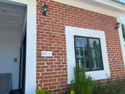 a brick wall with a window on a house at As Sufi Villa in Kampung Sungai Air Tawar