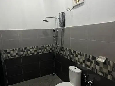 a bathroom with a toilet and a shower at As Sufi Villa in Kampung Sungai Air Tawar