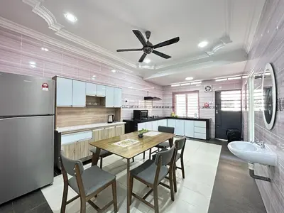 a kitchen with a dining table and a refrigerator at Ipoh Cozy Premium Spacious Home in Ipoh