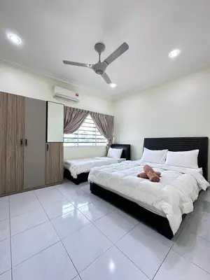 a bedroom with two beds and a ceiling fan at Ipoh Cozy Premium Spacious Home in Ipoh