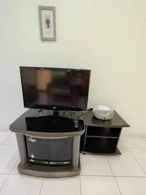 a flat screen tv sitting on top of a desk at Ipoh Cozy Premium Spacious Home in Ipoh