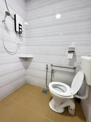 a bathroom with a toilet and a shower at Ipoh Cozy Premium Spacious Home in Ipoh