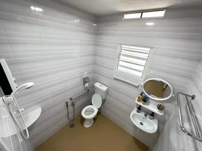 a white bathroom with a toilet and a sink at Ipoh Cozy Premium Spacious Home in Ipoh