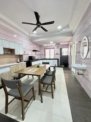 a kitchen with a table and chairs and a ceiling fan at Ipoh Cozy Premium Spacious Home in Ipoh