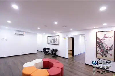 a room with a red and white chair and a painting at 15BR SwimmingPool Villa Golf View Snooker BBQ in Bayan Lepas