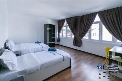 a bedroom with two beds and a table and windows at 15BR SwimmingPool Villa Golf View Snooker BBQ in Bayan Lepas