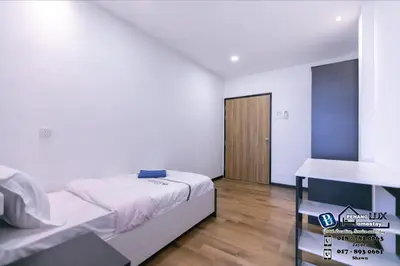 a bedroom with a bed and a table in it at 15BR SwimmingPool Villa Golf View Snooker BBQ in Bayan Lepas