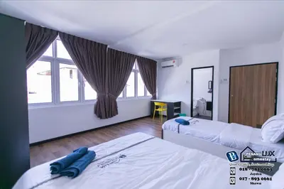 a hotel room with two beds and a window at 20BR SwimmingPool Villa Golf View Snooker BBQ in Bayan Lepas