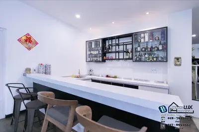 a bar with chairs and a counter with drinks at 20BR SwimmingPool Villa Golf View Snooker BBQ in Bayan Lepas