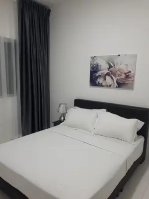 a bed with white sheets and pillows in a bedroom at Adsyahrizmal Homestay d'Cameron in Tanah Rata
