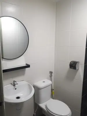 a bathroom with a toilet and a sink and a mirror at Adsyahrizmal Homestay d'Cameron in Tanah Rata