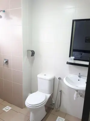 a white bathroom with a toilet and a sink at Adsyahrizmal Homestay d'Cameron in Tanah Rata