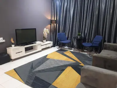 a living room with a flat screen tv and blue chairs at Adsyahrizmal Homestay d'Cameron in Tanah Rata