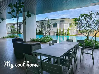 a patio with a table and chairs next to a pool at Sunway Onsen Hotsprings with Ipoh City View, Sunway Lost World in Ipoh