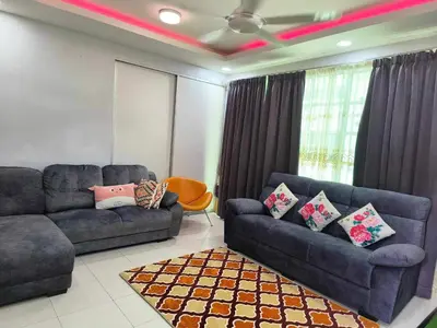 a living room with two blue couches and a rug at Trails of Kampar Villa Homestay in Kampar