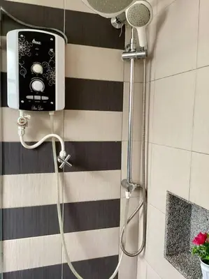 a shower in a bathroom with a shower head at Trails of Kampar Villa Homestay in Kampar