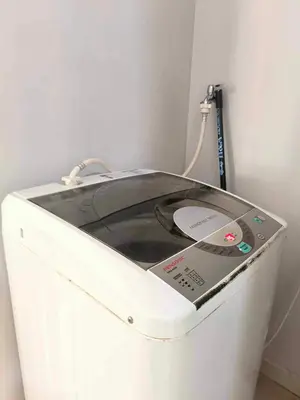 a washing machine sitting in a corner next to a wall at Trails of Kampar Villa Homestay in Kampar