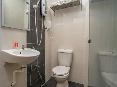 a bathroom with a toilet and a sink and a shower at Hotel The Island in Pangkor