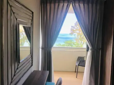 a room with a window with a view of the ocean at 5 Stars Seafront Suite By The Sea \u65e5\u843d\u65e0\u654c\u5168\u6d77\u666f 5\u661f \u9152\u5e97\u7b49\u7ea7 in Batu Ferringhi