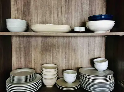 a bunch of plates and bowls on a shelf at 5 Stars Seafront Suite By The Sea \u65e5\u843d\u65e0\u654c\u5168\u6d77\u666f 5\u661f \u9152\u5e97\u7b49\u7ea7 in Batu Ferringhi