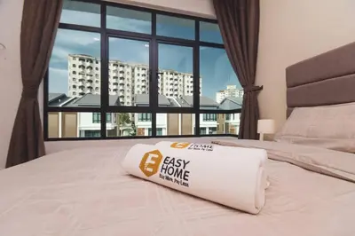a large bed with a easy home pillow on it at Luxury 3-sty semi-D 5BR 5Bath@Batu Ferringhi 15ppl in Batu Ferringhi