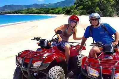 a man and woman riding on atvs on the beach at Luxury 3-sty semi-D 5BR 5Bath@Batu Ferringhi 15ppl in Batu Ferringhi