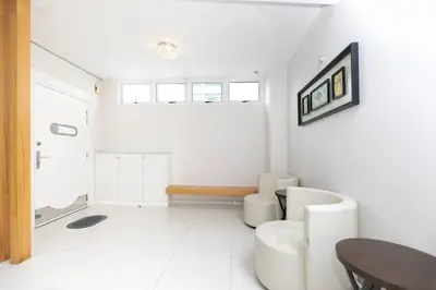 a white living room with a table and a couch at GeorgeTown PrivatePool Snooker 25Pax BBQ in George Town