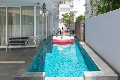 a swimming pool with an inflatable raft in the water at GeorgeTown PrivatePool Snooker 25Pax BBQ in George Town