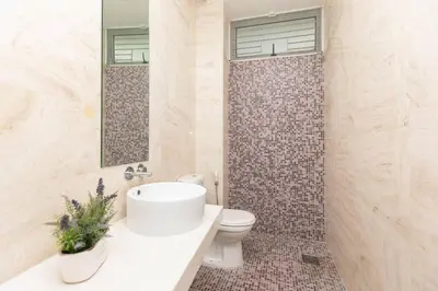 a bathroom with a white sink and a toilet at GeorgeTown PrivatePool Snooker 25Pax BBQ in George Town