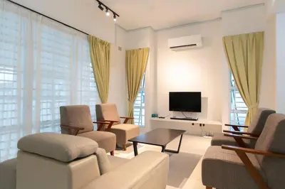 a living room with a couch and chairs and a tv at Penang Balik Pulau Swimming Pool BBQ KTV Homestay in Balik Pulau