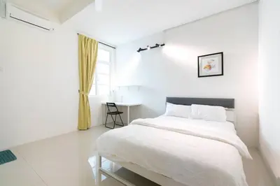 a white bedroom with a bed and a table at Penang Balik Pulau Swimming Pool BBQ KTV Homestay in Balik Pulau