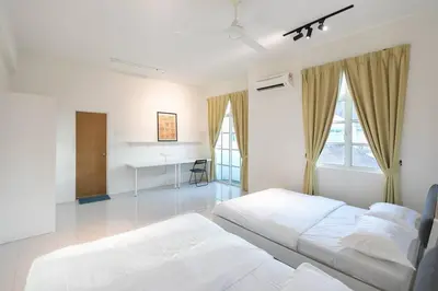 a white bedroom with two beds and a desk at Penang Balik Pulau Swimming Pool BBQ KTV Homestay in Balik Pulau