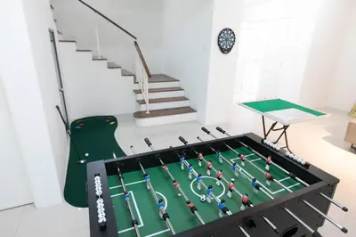 a room with a table with a tennis court at Penang Balik Pulau Swimming Pool BBQ KTV Homestay in Balik Pulau