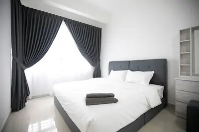 a bedroom with a white bed with a large window at Newly Renovated 3Bedroom Vacation Home 6-8pax in Bayan Lepas