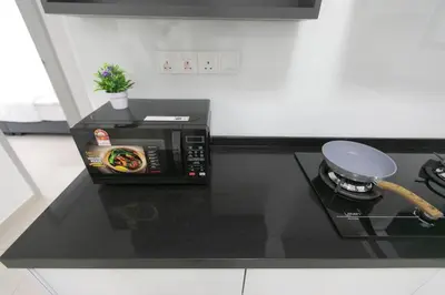 a microwave oven sitting on top of a kitchen counter at Newly Renovated 3Bedroom Vacation Home 6-8pax in Bayan Lepas