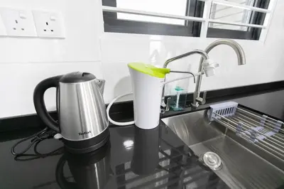 a coffee maker sitting on a counter next to a sink at Newly Renovated 3Bedroom Vacation Home 6-8pax in Bayan Lepas