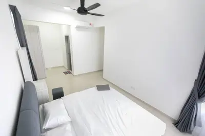 a bedroom with a bed and a ceiling fan at Newly Renovated 3Bedroom Vacation Home 6-8pax in Bayan Lepas