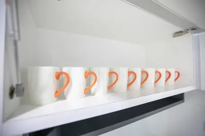 a row of coffee cups sitting on a shelf at Newly Renovated 3Bedroom Vacation Home 6-8pax in Bayan Lepas
