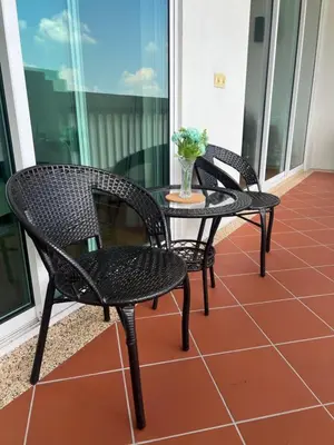 two chairs and a table on a balcony at 2Beds Seaview Straits Quay comes with Carpark and Hothub in Bagan Jermal