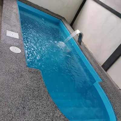 a swimming pool with a water fountain at Homestay Mohamad & Delisha Tapah -Pool in Tapah
