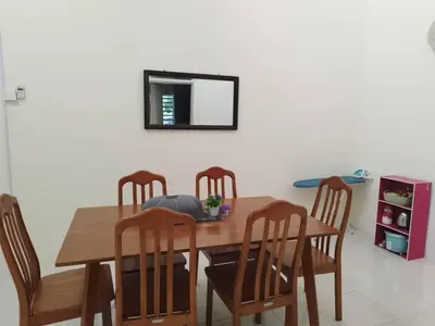 a dining room table with four chairs and a mirror at Homestay Mohamad & Delisha Tapah -Pool in Tapah