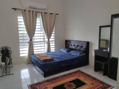 a bedroom with a bed and a large window at Homestay Mohamad & Delisha Tapah -Pool in Tapah