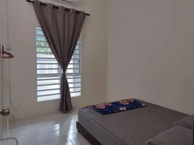 a bedroom with a bed and a window at Homestay Mohamad & Delisha Tapah -Pool in Tapah