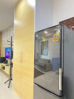 a refrigerator in a room with a living room at Lovely Cozy studio 3pax@mansion one Gurney in George Town