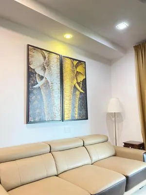 a living room with a couch and three pictures on the wall at Lovely Cozy studio 3pax@mansion one Gurney in George Town