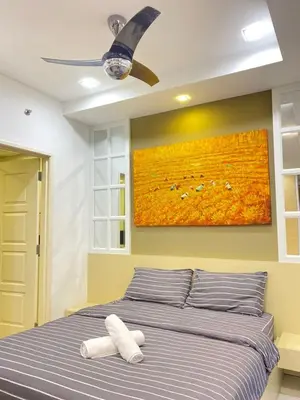 a bedroom with a bed with a painting on the wall at Lovely Cozy studio 3pax@mansion one Gurney in George Town