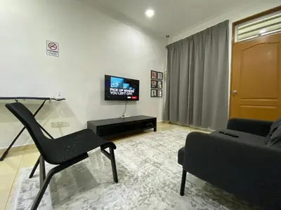 a living room with a chair and a couch at Deena's Cottage Homestay Kulim Hitech Hospital Kulim, Three bedrooms Single Storey Terrace House in Kulim