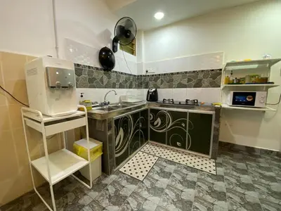 a small kitchen with a sink and a stove at Deena's Cottage Homestay Kulim Hitech Hospital Kulim, Three bedrooms Single Storey Terrace House in Kulim