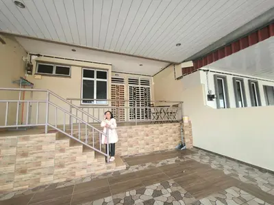 a woman standing in front of a house at Deena's Cottage Homestay Kulim Hitech Hospital Kulim, Three bedrooms Single Storey Terrace House in Kulim
