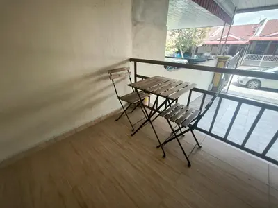 a balcony with a table and two chairs on it at Deena's Cottage Homestay Kulim Hitech Hospital Kulim, Three bedrooms Single Storey Terrace House in Kulim